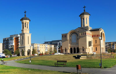 View of buildings against clear blue sky