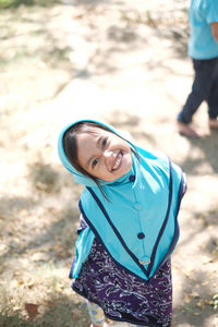 Portrait of smiling girl standing on land