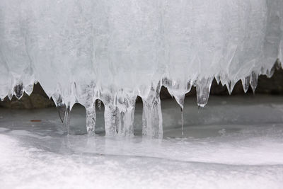 View of beautiful drawings on ice from cracks on the surface of lake teletskoye in winter, russia