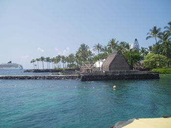 Built structure by sea against sky