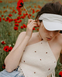 Side view of woman holding yellow flower