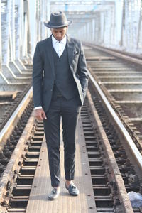 Full length of man standing on railroad track