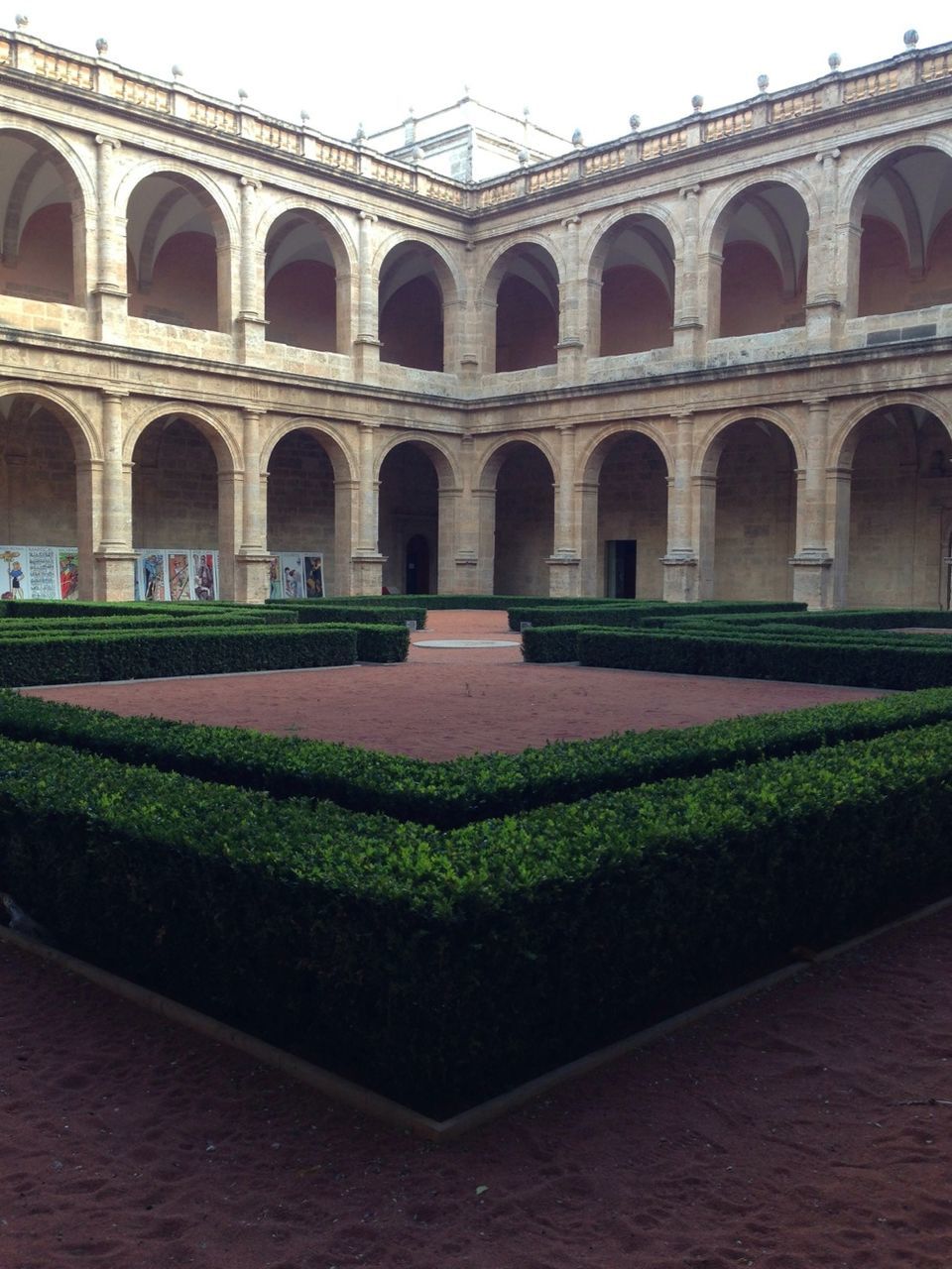 architecture, built structure, building exterior, arch, grass, lawn, green color, window, facade, history, building, architectural column, day, outdoors, plant, no people, courtyard, in a row, sky, travel destinations