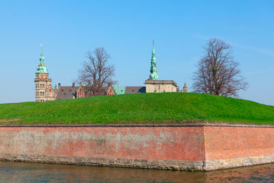 Castle surrounded by water canal . kronborg slot with fortification in helsingor, denmark