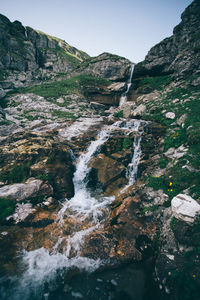 Scenic view of waterfall against sky