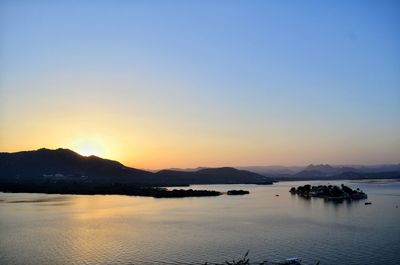 Scenic view of lake against clear sky during sunset, udaipur 