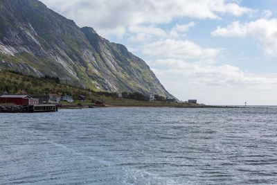 Scenic view of sea by buildings against sky