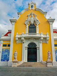 Low angle view of statue against building against sky