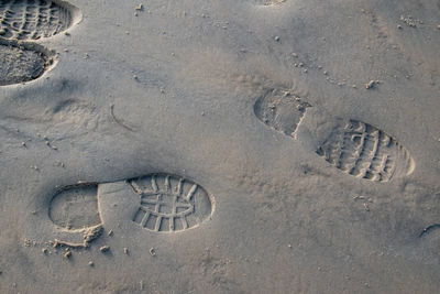 High angle view of footprints on sand