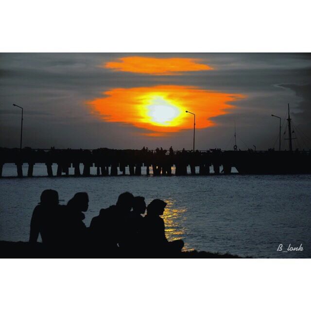 sunset, transfer print, silhouette, water, sky, auto post production filter, sea, men, reflection, lifestyles, scenics, orange color, cloud - sky, leisure activity, person, nature, beauty in nature, tranquil scene, tranquility