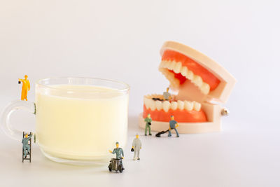 Close-up of drink on table against white background