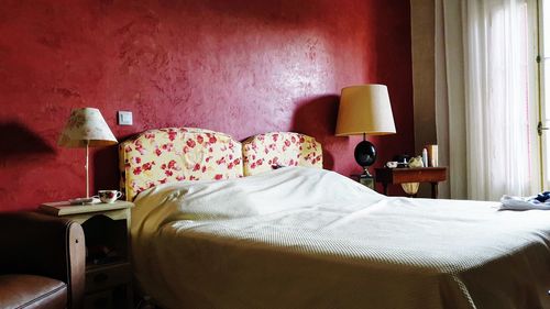 View of messy bed in bedroom