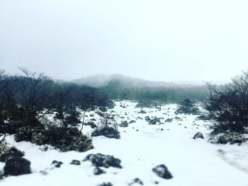 Scenic view of snow covered mountains against clear sky