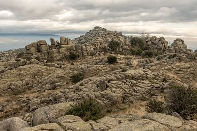 Rock formations on landscape against sky