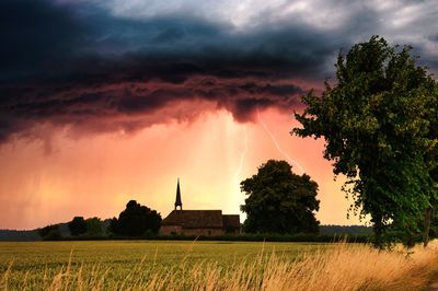 Panoramic view of field against sky during storm