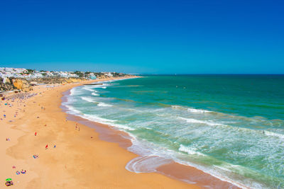 Scenic view of beach against clear blue sky