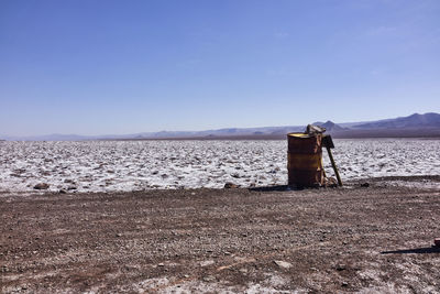 Barrel at atacama desert against clear blue sky