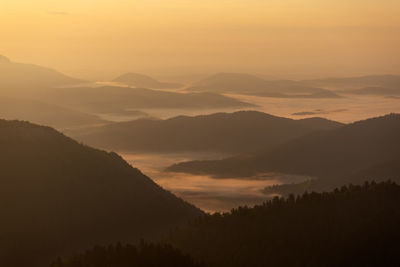 Scenic view of mountains against sky during sunset