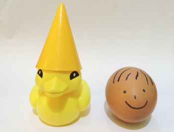 Close-up of yellow toy over white background