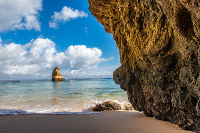 Scenic view of rocks in sea against sky