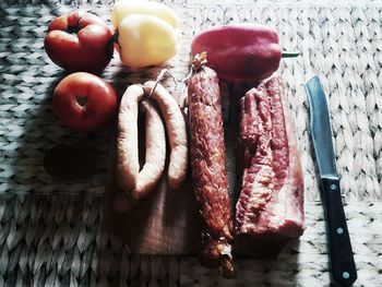 High angle view of meat and bell peppers on cutting board