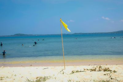 Scenic view of beach against blue sky