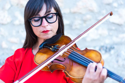 Close-up of woman playing violin