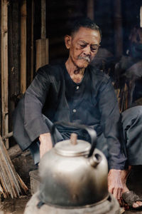 Portrait of senior man working at kitchen