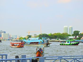 Boats in city against clear sky
