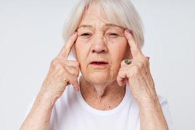 Portrait of young woman against white background