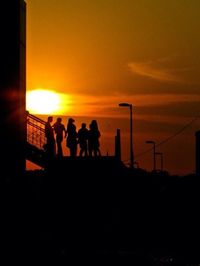Silhouette of people at sunset