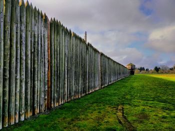 Fence on field against sky
