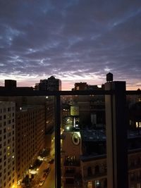 Illuminated cityscape against sky at sunset