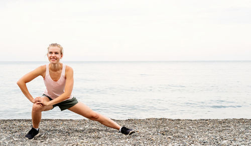 Full length of senior man on beach against sky