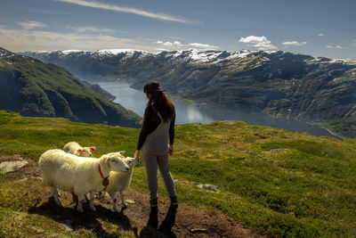 Woman standing with sheep