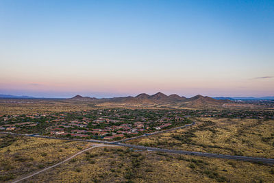 Scenic view of landscape against clear sky during sunset