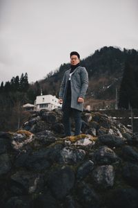 Portrait of young man standing on rock