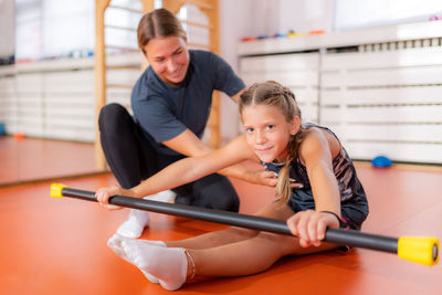 Back and hamstring flexion with a bar, exercise for children