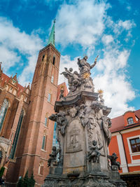 Low angle view of statue against historic building