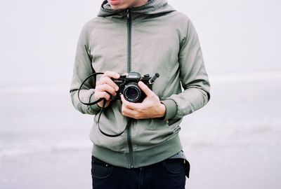 Close-up of woman holding camera