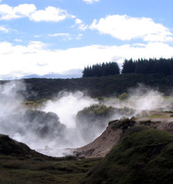 Scenic view of waterfall against sky