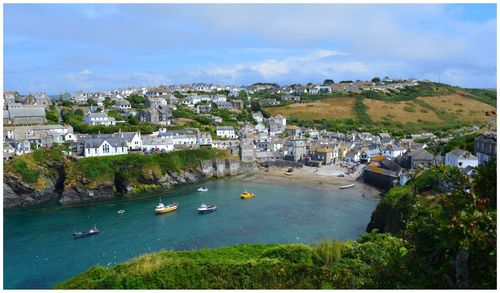 High angle view of townscape by sea against sky