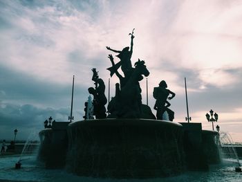 Low angle view of statue against cloudy sky