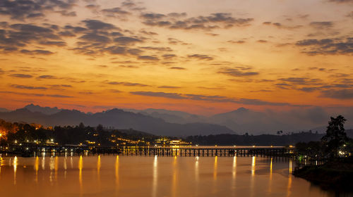 Scenic view of lake against orange sky