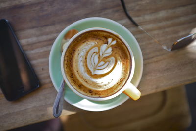 Close-up of cappuccino on wooden table