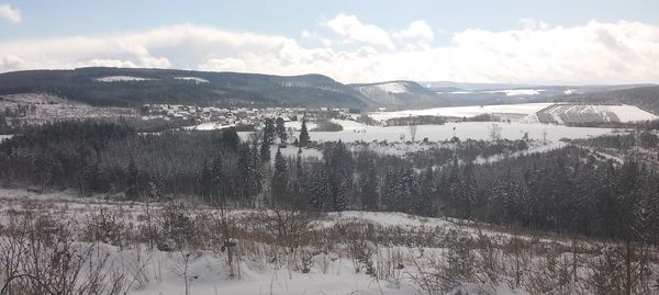 Scenic view of landscape against sky during winter