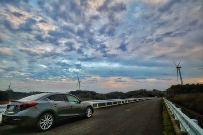 Car on road against sky during sunset