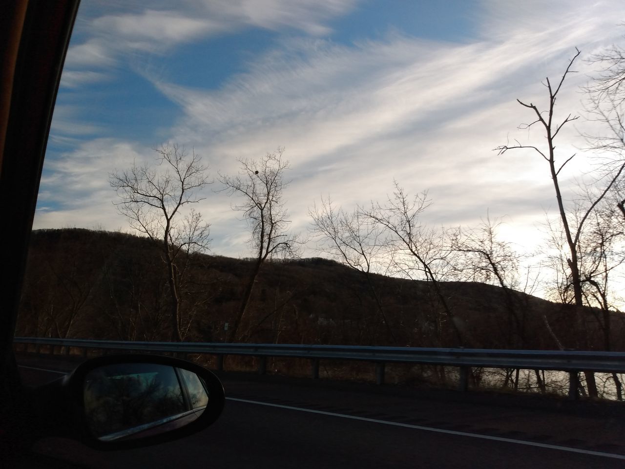 CAR ON ROAD AGAINST SKY SEEN THROUGH GLASS WINDOW