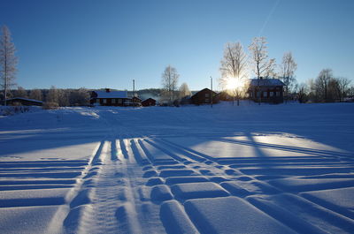 Snow covered city against clear sky