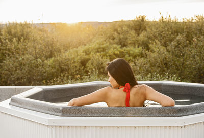 Beautiful woman relaxing in hot tub at holiday villa in iceland